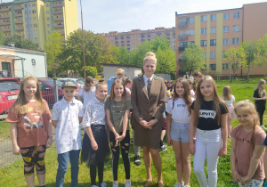 Dzieci z panią leśnik sadzą drzewko