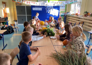 Dzieci siedzące przy stole z kwiatami