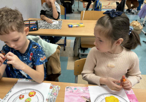 Dzieci wykonują kolorową pracę plastyczną