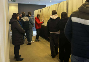 Grupa młodzieży ogląda księgi