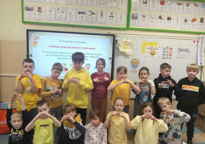 Grupa radosnych dzieci w żółtych bluzkach